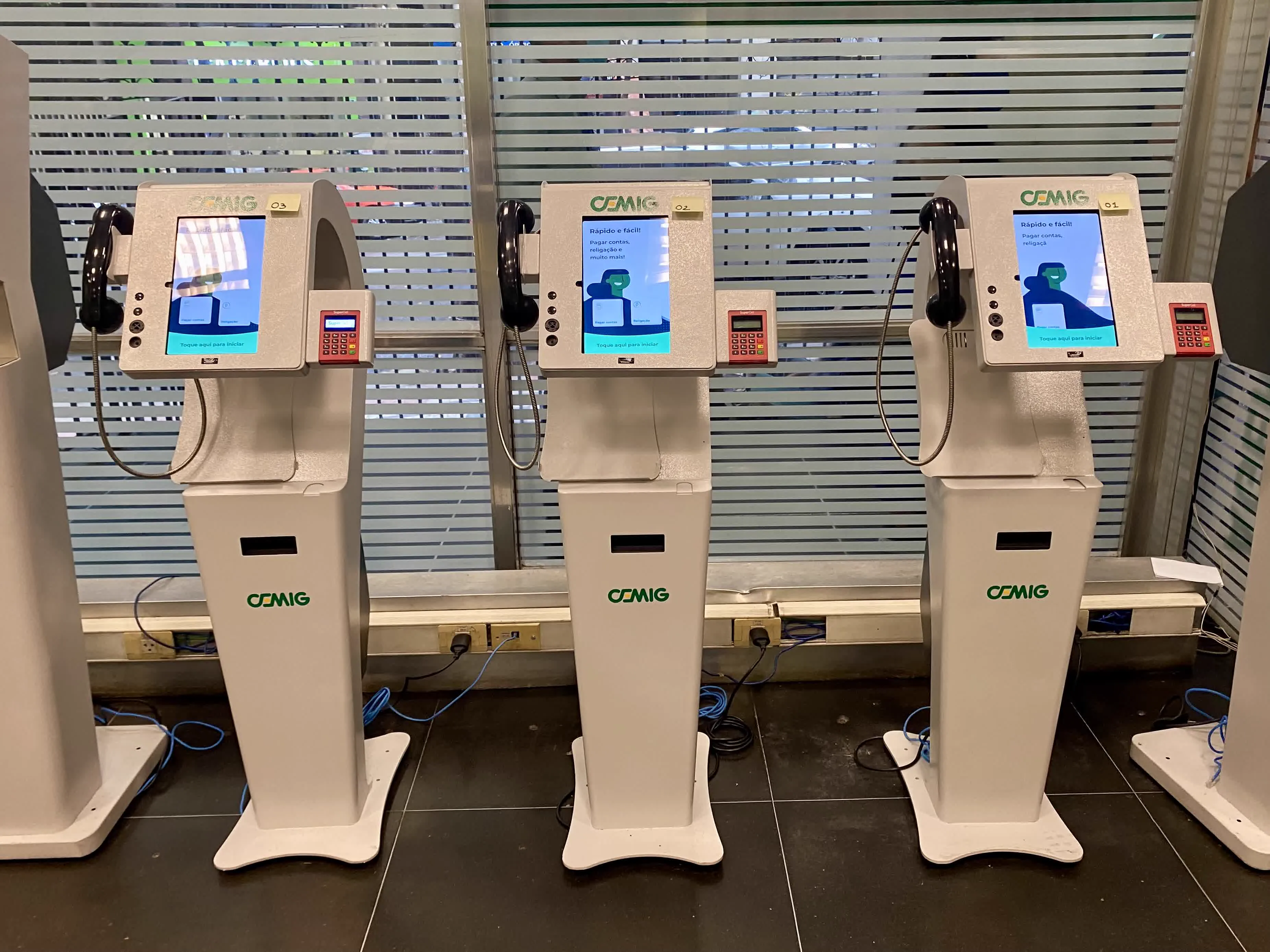 The self-service totem — deployed across agencies — and the looping screen idle I animated for it